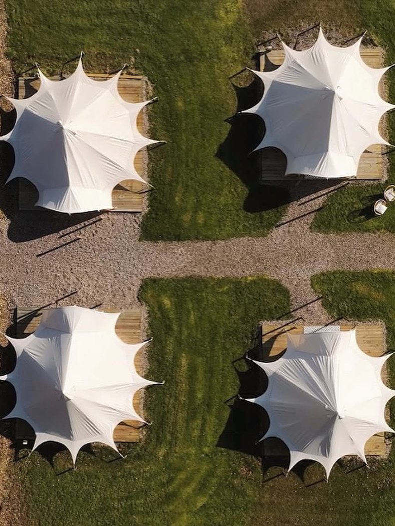 Luxury bell tents set up for hen party glamping weekend in the countryside
